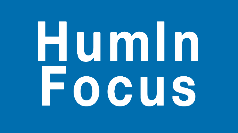 Image is a blue background with white text that says "HumIn Focus"