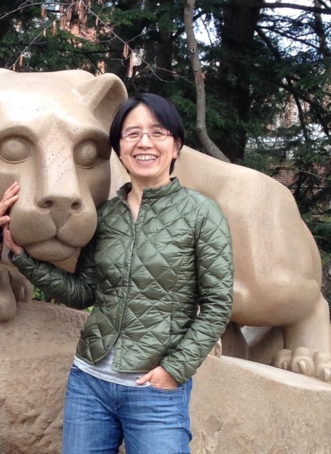 Photo of Faculty Shuang Shen posing next to the Nittany Lion.