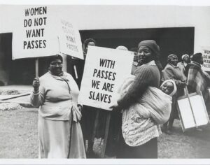a black and white picture of women holding signs that read 